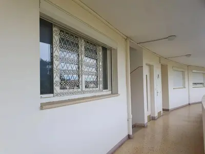 an empty hallway with a window in a building at Appartement moderne avec vue mer à Cannes in Cannes