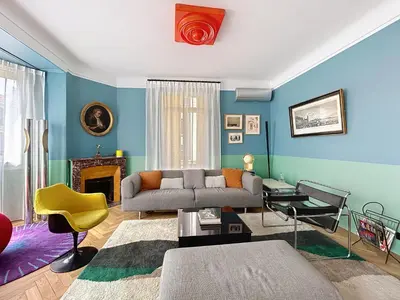 a living room with blue walls and a couch at Vega in Cannes
