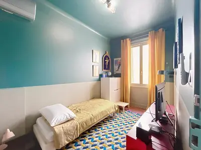 a bedroom with a bed and a tv in it at Vega in Cannes