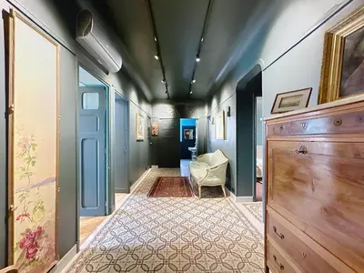 a hallway with a room with blue walls and a chair at Vega in Cannes