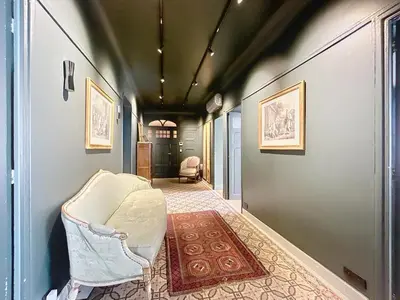 a hallway with a chair and a rug at Vega in Cannes