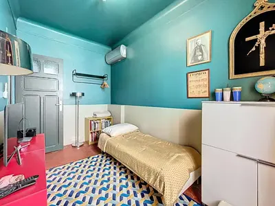 a bedroom with a bed and a blue wall at Vega in Cannes