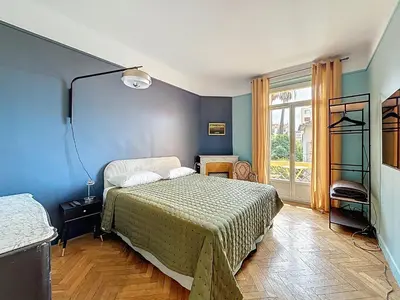 a bedroom with a bed and a blue wall at Vega in Cannes