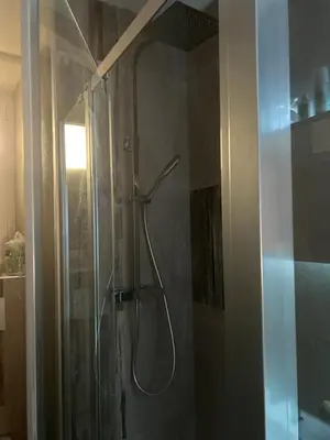 a shower with a shower head in a bathroom at Entire studio Cannes Raphael in Cannes