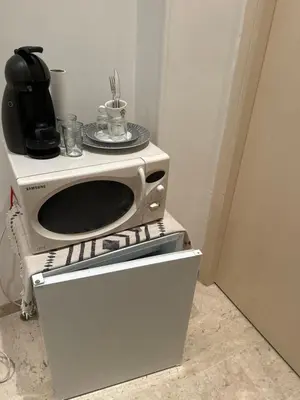 a microwave oven sitting on top of a white cabinet at Entire studio Cannes Raphael in Cannes