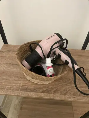 a hair dryer in a basket on a table at Entire studio Cannes Raphael in Cannes