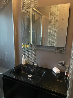 a white bathroom with a toilet and a window at Studio Love Room Rooftop Jacuzzi SCLS Rentals in Cannes