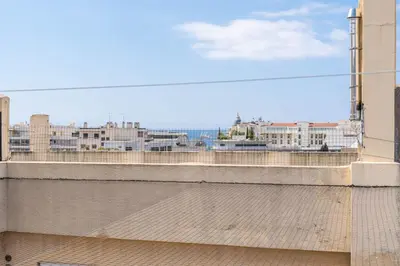 a table and chairs on a balcony with a view at Studio Love Room Rooftop Jacuzzi SCLS Rentals in Cannes