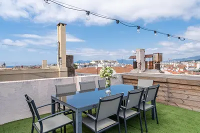 a vase of flowers sitting on top of a table at Studio Love Room Rooftop Jacuzzi SCLS Rentals in Cannes