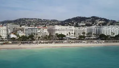 a view of a beach with buildings and the ocean at Palais Miramar Croisette 2 BRD Gold Suite in Cannes