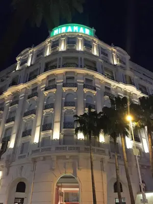 a large white building with a green light on top at Palais Miramar Croisette 2 BRD Gold Suite in Cannes