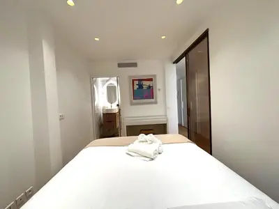 a bedroom with a white bed with a towel on it at Palais Miramar Croisette 2 BRD Gold Suite in Cannes