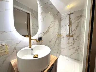 a bathroom with a white sink and a mirror at Palais Miramar Croisette 2 BRD Gold Suite in Cannes