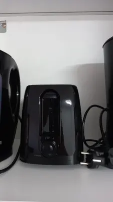 a black toaster sitting on a white shelf at Beachfront 4 people 2 swimming pool in Cannes