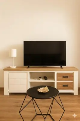 a living room with a tv and a coffee table at Beachfront 4 people 2 swimming pool in Cannes