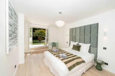 a bedroom with a large bed and a window at Sumptuous villa - AC- 6BR- 12P- Cannes in Cannes