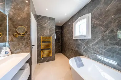 a bathroom with a tub and a sink at Sumptuous villa - AC- 6BR- 12P- Cannes in Cannes