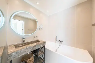 a bathroom with a tub and a sink and a mirror at Sumptuous villa - AC- 6BR- 12P- Cannes in Cannes
