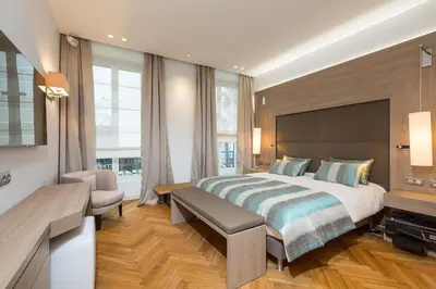 a large bedroom with a large bed and a window at Cannes Croisette 4 bedrooms - 2C in Cannes