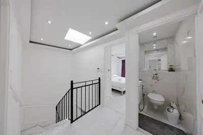 a white bathroom with a toilet and a sink at Cannes 3 bedrooms apartment - 14HV in Cannes
