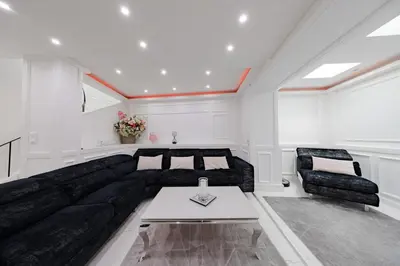 a living room with a black couch and a table at Cannes 3 bedrooms apartment - 14HV in Cannes