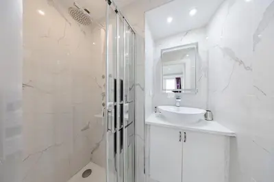a white bathroom with a sink and a shower at Cannes 3 bedrooms apartment - 14HV in Cannes