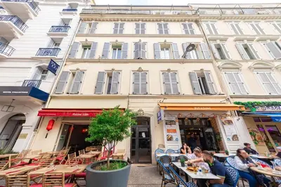 a group of people sitting at tables in front of a building at Cannes 3 bedrooms apartment - 14HV in Cannes