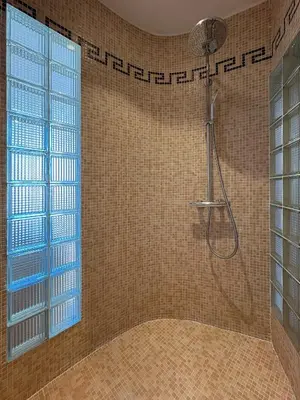 a bathroom with a shower with a glass door at Charmante maison de village avec petite piscine privée in Le Cannet