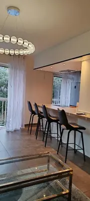 a dining room with chairs and a table in a room at T2 chic non loin de palais festival in Cannes