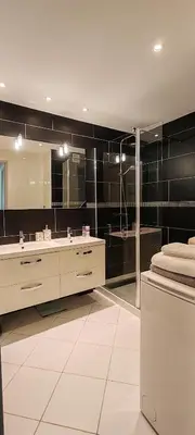 a bathroom with a sink and a large mirror at T2 chic non loin de palais festival in Cannes