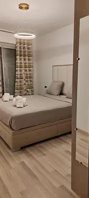 a bedroom with a large bed and a chandelier at T2 chic non loin de palais festival in Cannes