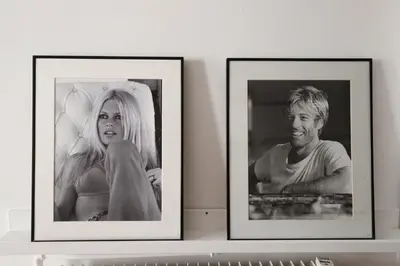 two framed photographs of a man and a woman on a shelf at Chic 1-bedroom apartment steps away from La Croisette in Cannes