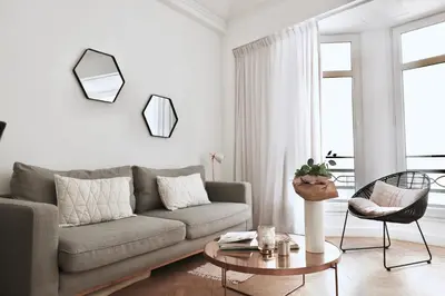 a living room with a couch and a table at Chic 1-bedroom apartment steps away from La Croisette in Cannes