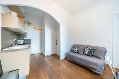 a living room with a couch and a kitchen at Au coeur du Suquet - 2 pièces cosy - Climatisation séjour in Cannes