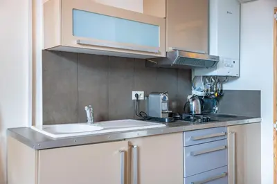 a kitchen with a sink and a microwave at Au coeur du Suquet - 2 pièces cosy - Climatisation séjour in Cannes