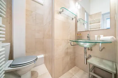 a bathroom with a toilet and a sink and a shower at Au coeur du Suquet - 2 pièces cosy - Climatisation séjour in Cannes