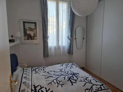 a bedroom with a bed and a window at Terrasse Bergerie in Cannes