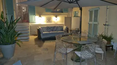 a patio with a table and chairs and a couch at Terrasse Bergerie in Cannes