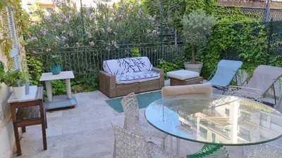a patio with a glass table and chairs at Terrasse Bergerie in Cannes