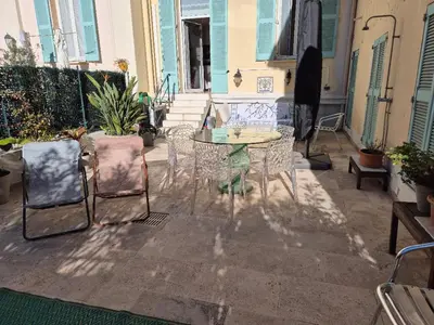 a patio with a table and chairs on a house at Terrasse Bergerie in Cannes