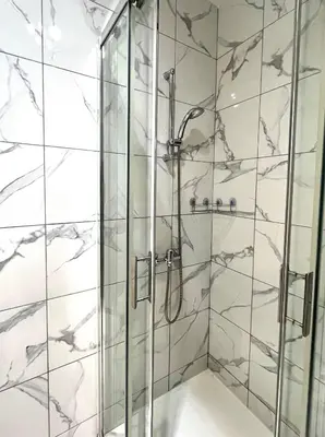 a bathroom with a shower with a glass door at T2 cosy, calme à 5 min de la Croisette in Le Cannet