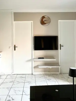 a living room with a flat screen tv on a wall at T2 cosy, calme à 5 min de la Croisette in Le Cannet