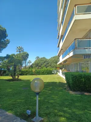 a gold ball in the grass in front of a building at Cannes Studio Vue mer Panoramique Château de la Mer in Cannes
