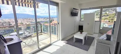 a living room with a view of a city at Cannes Studio Vue mer Panoramique Château de la Mer in Cannes