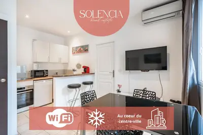 an apartment with a kitchen and a table with chairs at 2 Pièces vieille-ville Cannes - Suquet - Proche Palais et Croisette in Cannes