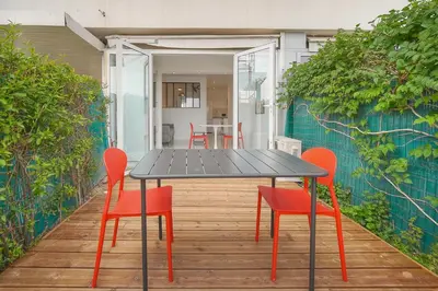a black table and red chairs on a patio at Le Cali - Front de mer - Palm Beach - VCA in Cannes
