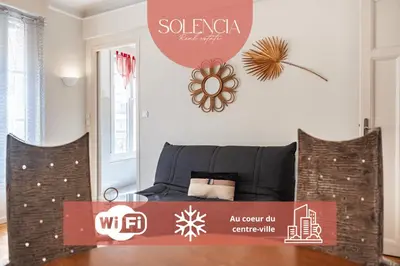 a room with a bed with a sign on the wall at 3 pièces centre-ville Cannes - Croisette - Climatisation séjour in Cannes