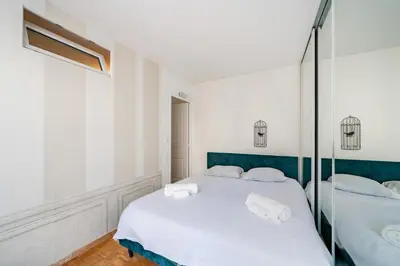 a bedroom with two beds with white sheets and towels at 3 pièces centre-ville Cannes - Croisette - Climatisation séjour in Cannes