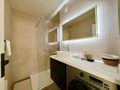 a bathroom with a sink and a washing machine at C018 - Lumineux Appartement - Proche plage in Cannes