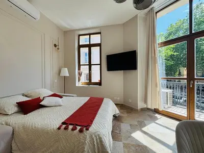 a bedroom with a bed and a large window at Le Sainte Rose Standing, Cannes center on foot in Cannes